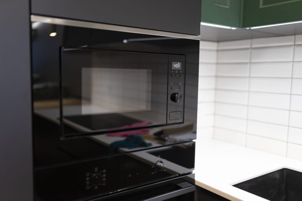 A black built-in microwave above an oven