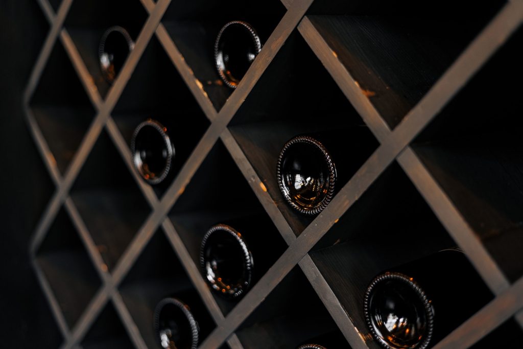 Bottle ends resting in a diamond wooden rack