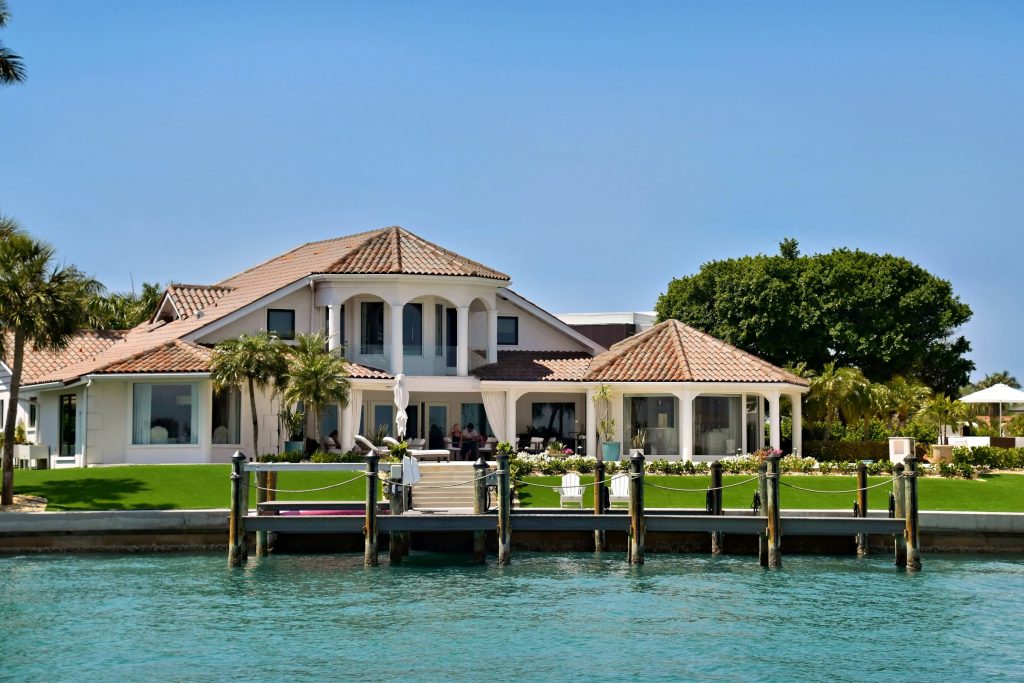 A waterfront house with a private dock on calm turquoise water