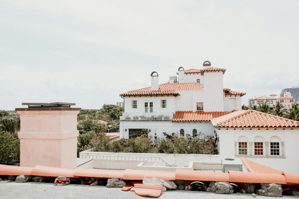 Barrel-tile roofs of Mediterranean revival houses above the treeline